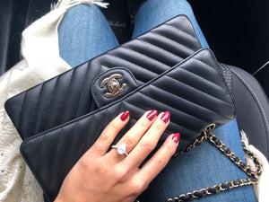 Woman Holding Chanel Black Chevron Medium Flap Bag